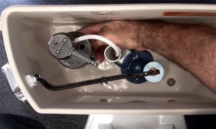 How do I adjust the water level in my toilet Toto?
