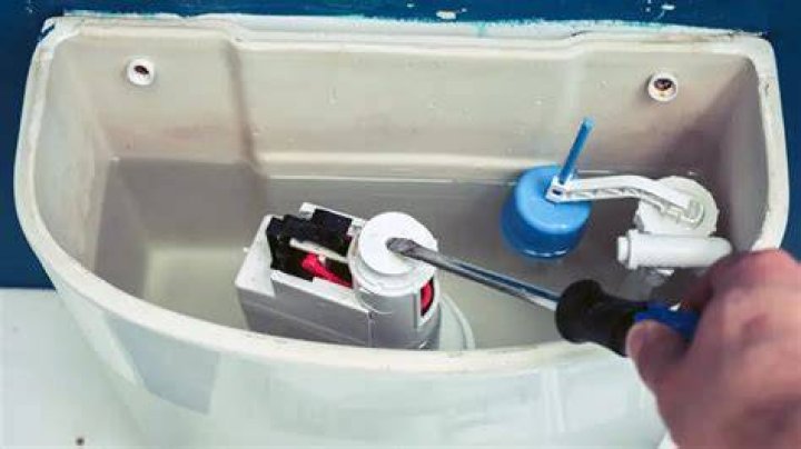 How do I lower the water level in my toilet tank?
