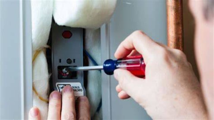 How do you adjust the water temperature on a Rheem?