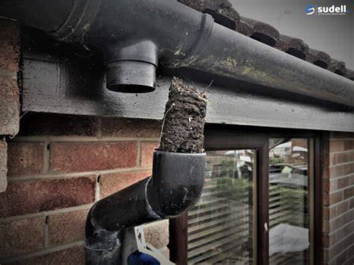 How do you clear a blocked rainwater downpipe?