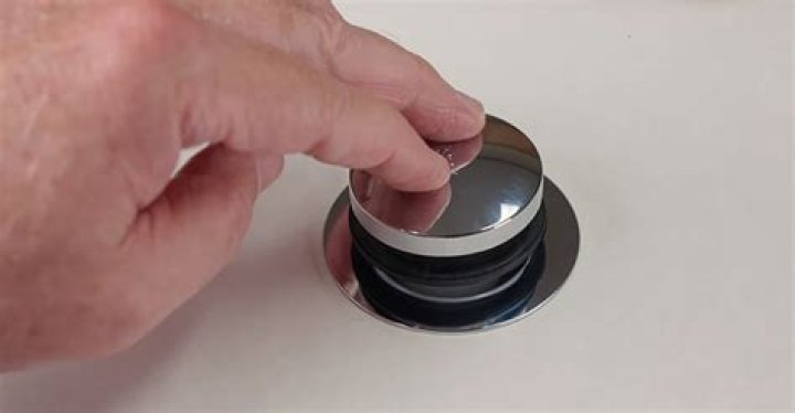 How do you close a toe touch drain stopper?