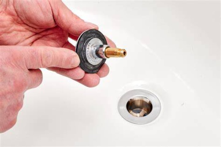 How do you get a bathtub drain stopper back in?
