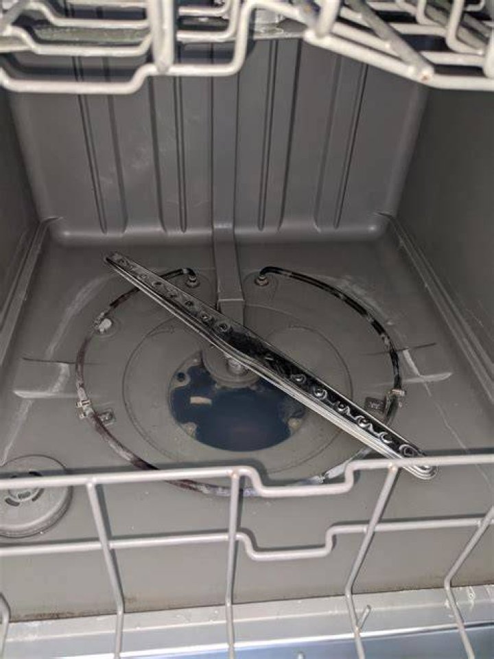 How do you get rid of standing water in the dishwasher?