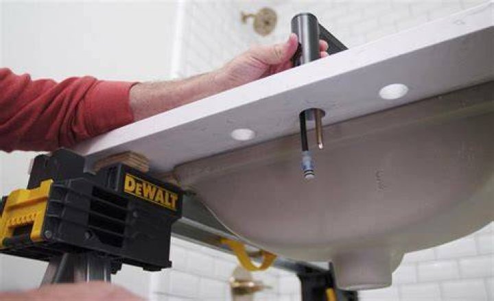 How do you install a sink on a vanity?