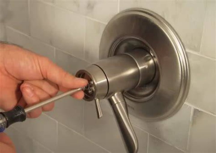 How do you remove a Delta Roman tub handle?