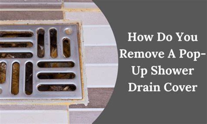 How do you remove grout from a shower drain?