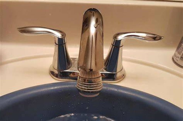 How do you remove the handle on a Moen bathroom sink?