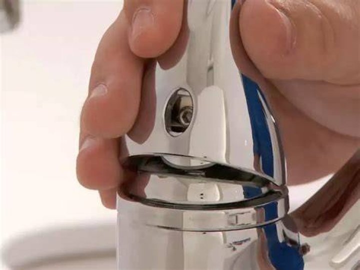 How do you take the cap off a Delta faucet?