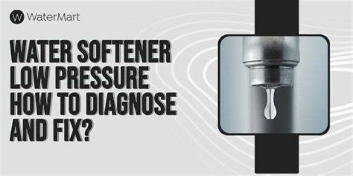 What causes low water pressure with a water softener?