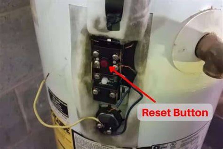 Where is the reset button on a whirlpool hot water tank?