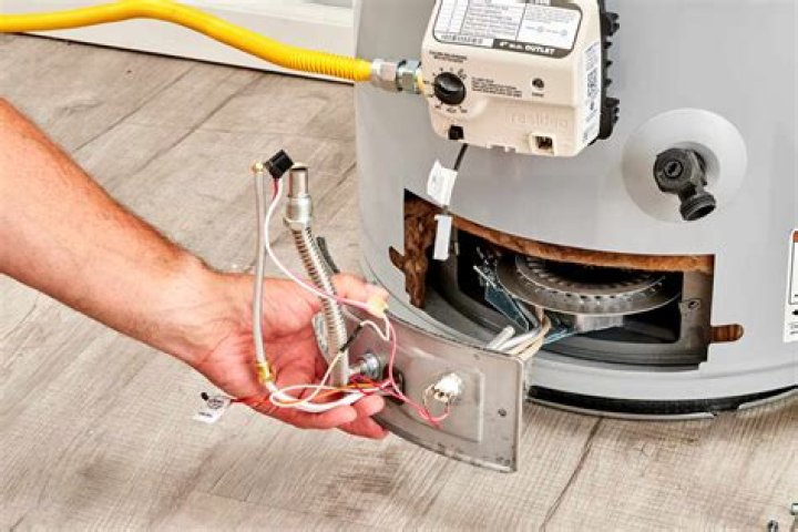 Where is the thermostat on a GE water heater?