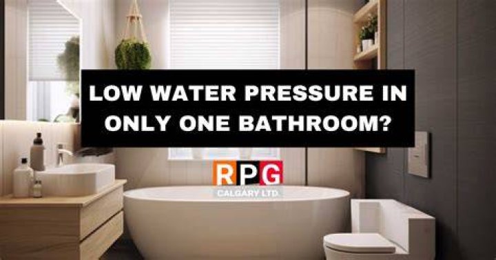 Why do I have low water pressure in one bathroom?