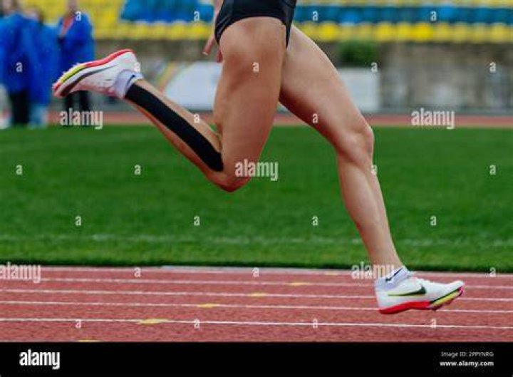 Why do runners wear spiked shoes?