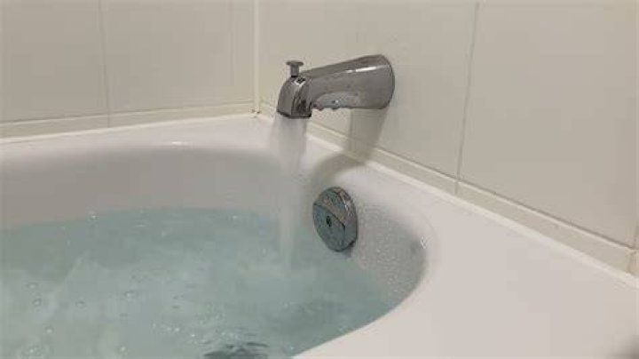 Why does my bathtub fill with water when I turn on the sink?