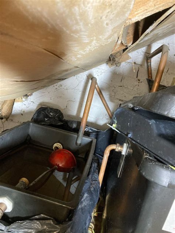 Why is my central heating expansion tank overflowing?